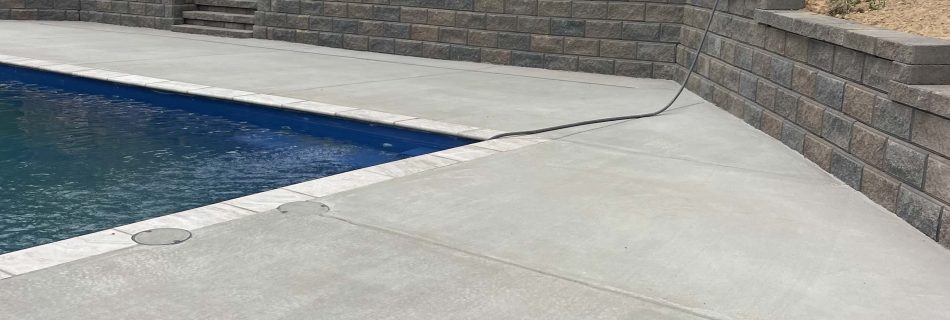 Concrete contractor work by EJ Concrete - Retaining Wall, concrete around the pool, residential home.